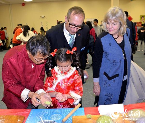 芝北中文中心校长孙彦钊在教小朋友如何包饺子。(张大卫 摄)
