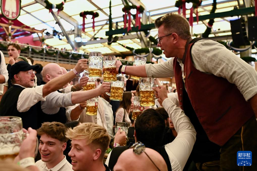 9月20日，人们在德国慕尼黑啤酒节上享用啤酒。新华社记者 张豪夫 摄