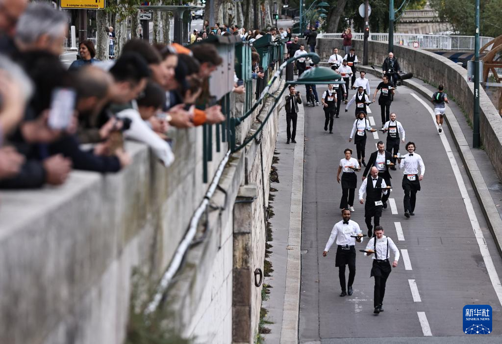 9月21日，参赛者在法国巴黎参加服务员赛跑。新华社记者 高静 摄