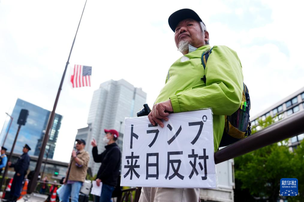 10月28日，在日本东京的首相官邸外，示威者手举标语参加抗议活动。新华社记者 贾浩成 摄
