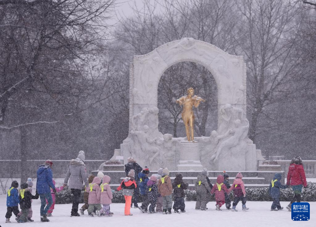 1月9日，在奥地利维也纳城市公园，人们从小约翰·施特劳斯雕像前路过。新华社记者 贺灿铃 摄