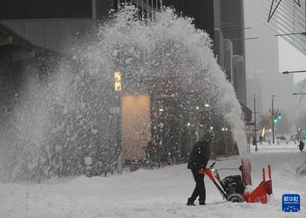 1月25日，一名男子清理美国纽约街头积雪。新华社记者 张凤国 摄