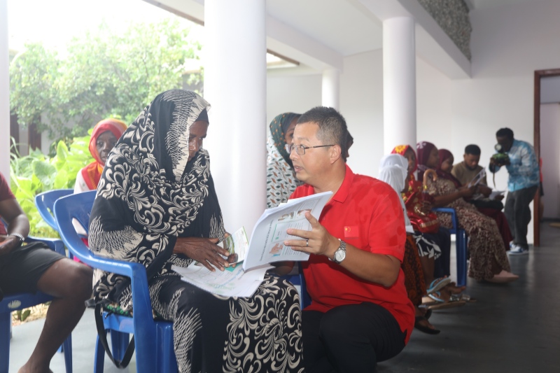 刘耀宝医生向当地群众发放防疟科普材料。中国援桑医疗队供图(1)