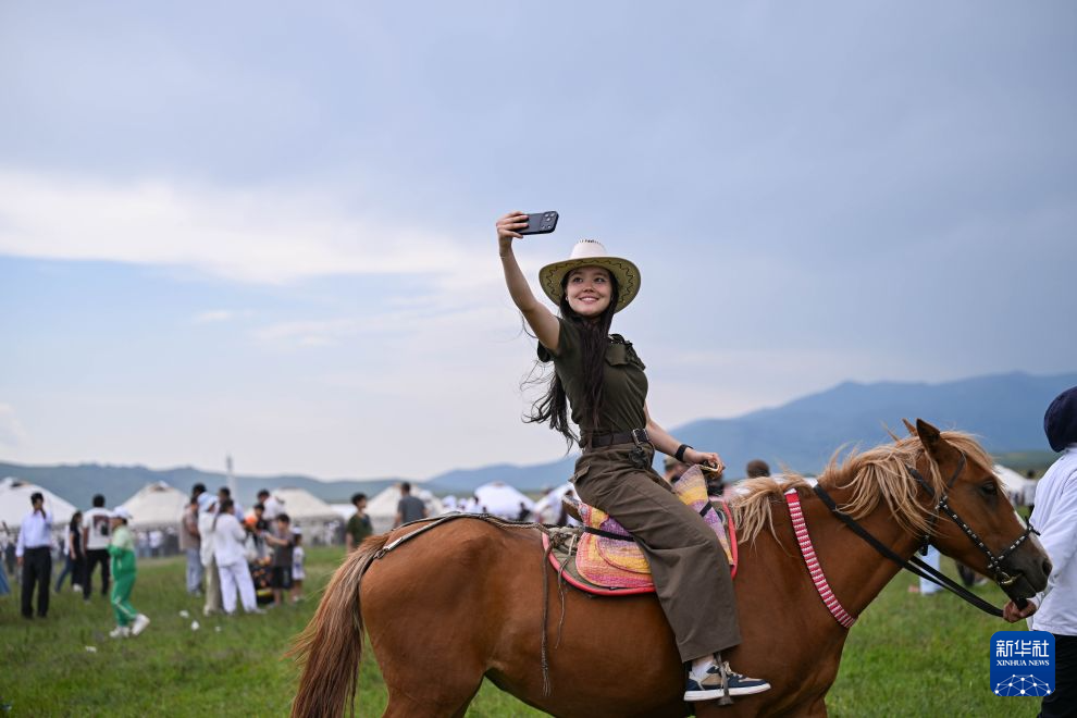 6月27日，在哈萨克斯坦阿拉木图州卡尔卡拉，一名女子骑马自拍。