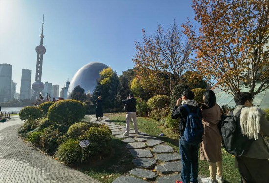 12月9日,一群外国游客在上海北外滩“小巨蛋”前排队拍照。新华社记者 陈爱平 摄